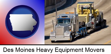 a semi-truck hauling heavy construction equipment in Des Moines, IA