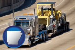 arkansas map icon and a semi-truck hauling heavy construction equipment