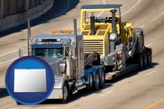 colorado map icon and a semi-truck hauling heavy construction equipment
