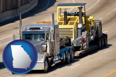 georgia map icon and a semi-truck hauling heavy construction equipment