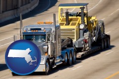 massachusetts map icon and a semi-truck hauling heavy construction equipment