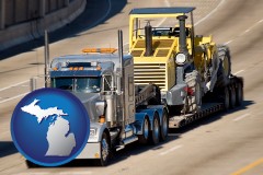 michigan map icon and a semi-truck hauling heavy construction equipment