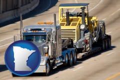minnesota map icon and a semi-truck hauling heavy construction equipment