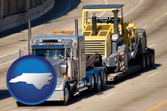 north-carolina map icon and a semi-truck hauling heavy construction equipment