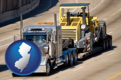 new-jersey map icon and a semi-truck hauling heavy construction equipment