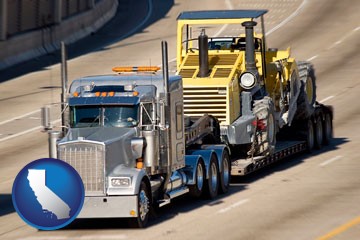 a semi-truck hauling heavy construction equipment - with California icon