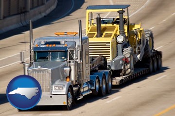 a semi-truck hauling heavy construction equipment - with North Carolina icon